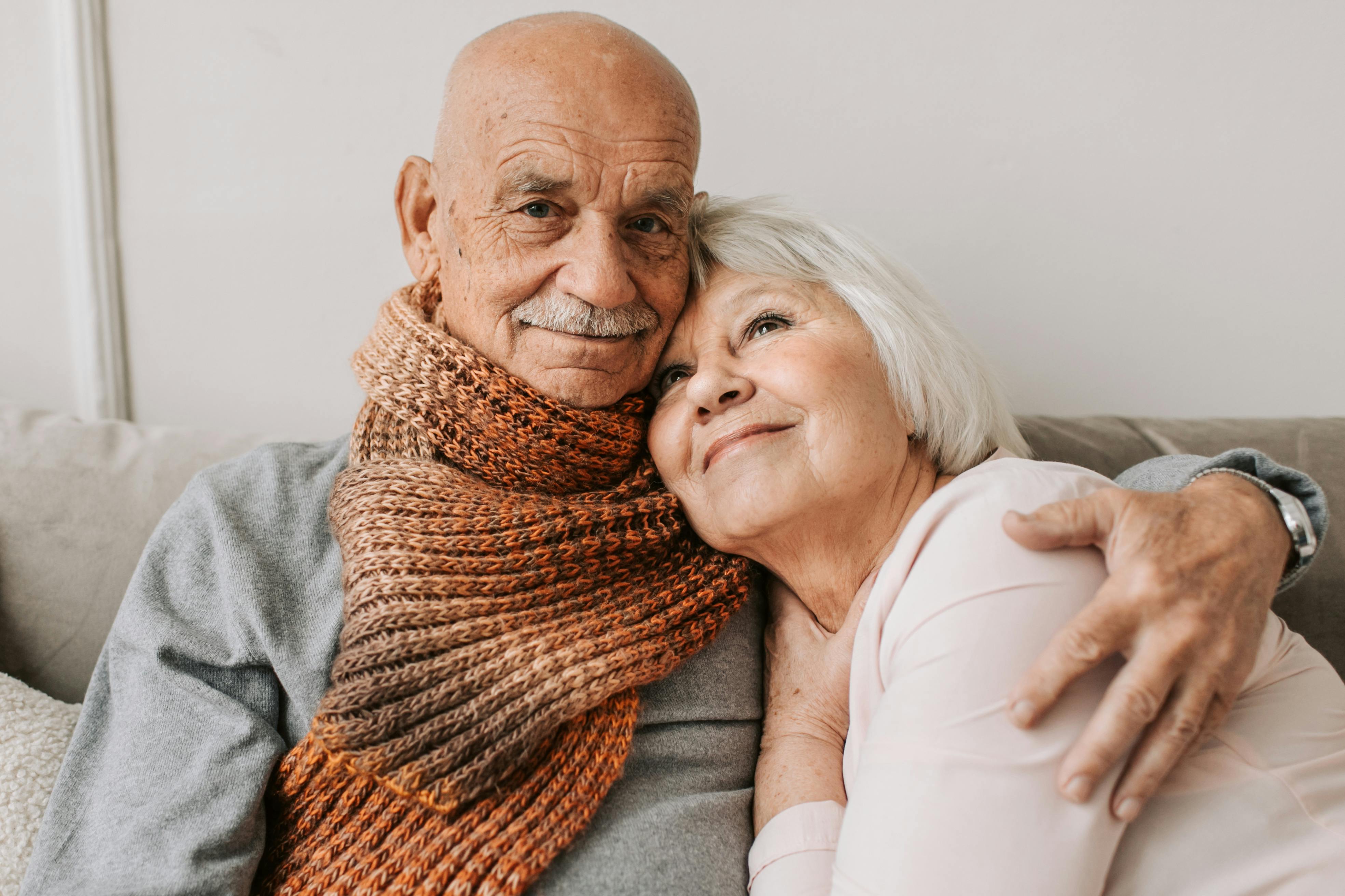 A close portrait of an older couple smiling together.